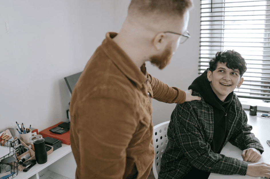 behaviour support man putting hand on shoulder
